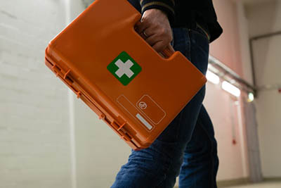 homme tenant une trousse de premier secours